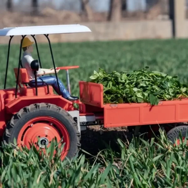 rc-tractor-metal Remote control tractor hobby model T16 in the field carrying plants